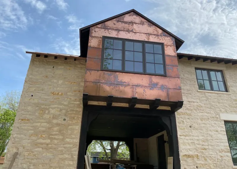 Copper metal panel facade on a stone building for Skylight Installation in East Allen